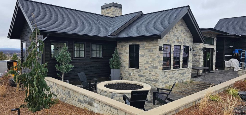 Dark siding and custom stone work on home in la pine Oregon